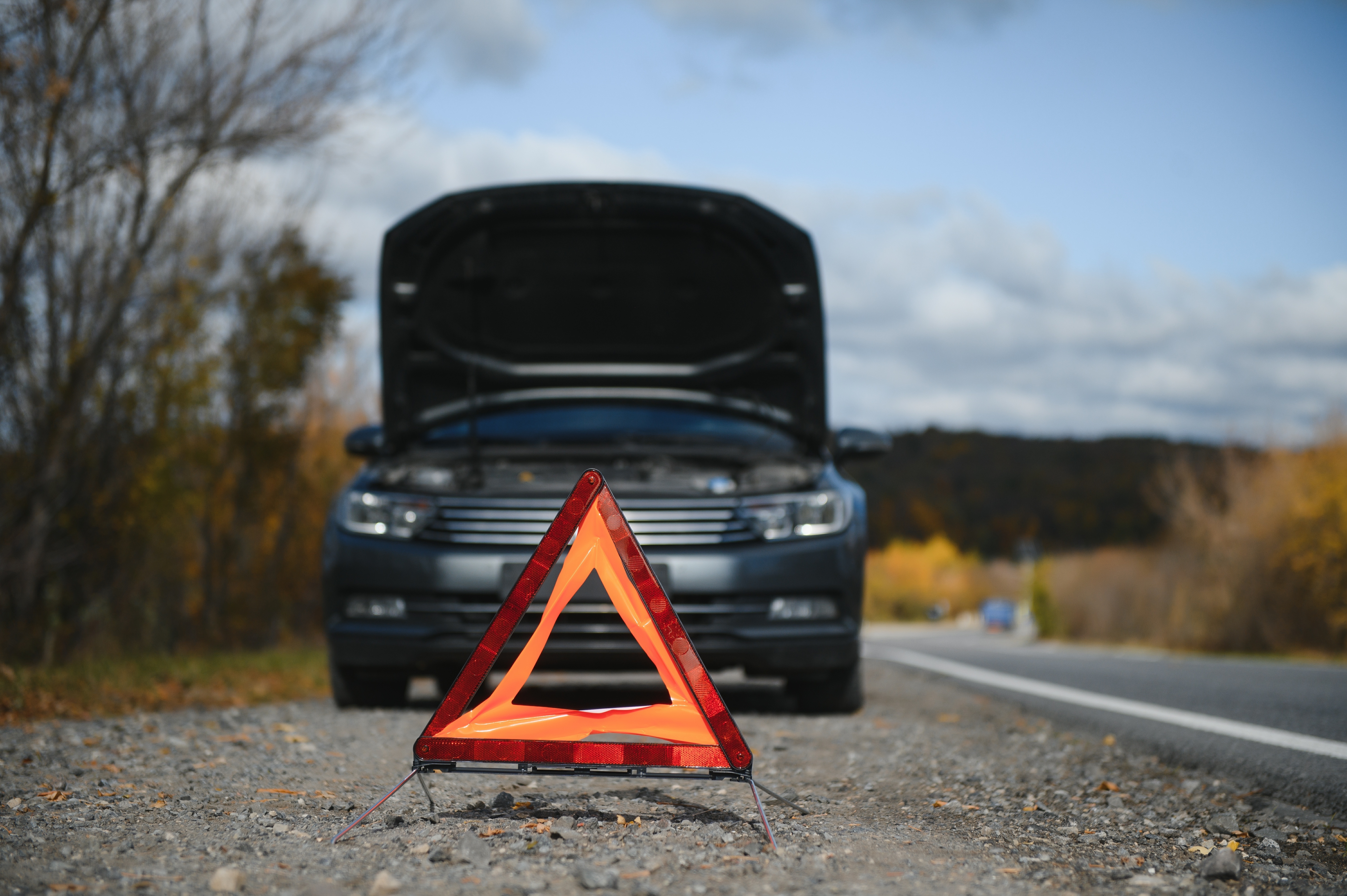 Broken down car with triangle infront.jpg